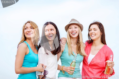 Image of girls with drinks on the beach