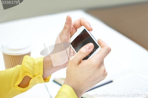 Image of close up of female hands with smartphone at home