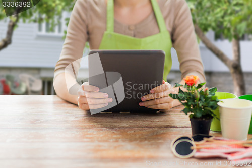 Image of close up of woman or gardener holding tablet pc