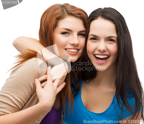 Image of two laughing girls hugging