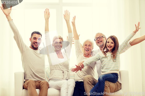 Image of happy family sitting on sofa at home