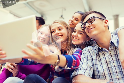 Image of group of smiling students with tablet pc
