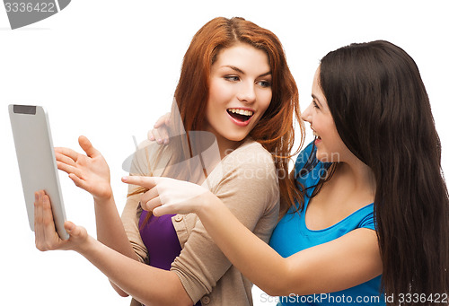 Image of two smiling teenages with tablet pc computer