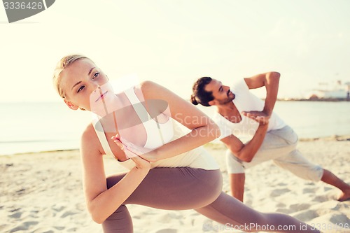 Image of close up of couple making yoga exercises outdoors