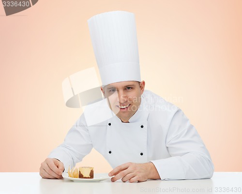 Image of happy male chef cook with dessert