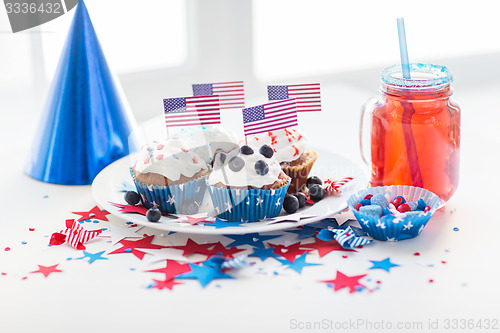 Image of cupcakes with american flags on independence day