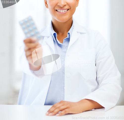 Image of doctor with blister packs of pills