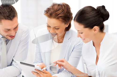 Image of business team working with tablet pcs in office