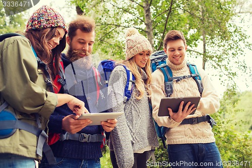 Image of group of friends with backpacks and tablet pc