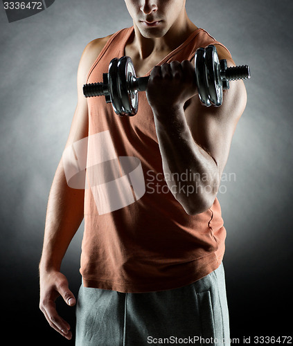 Image of young man with dumbbell