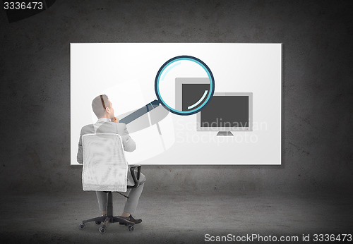 Image of businessman over computer and magnifier on screen