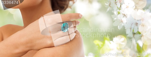 Image of close up of woman with cocktail ring on hand