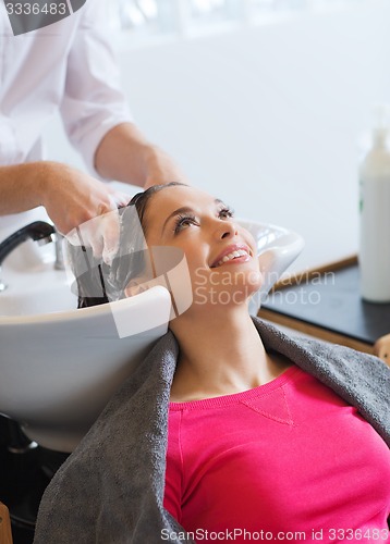 Image of happy young woman at hair salon