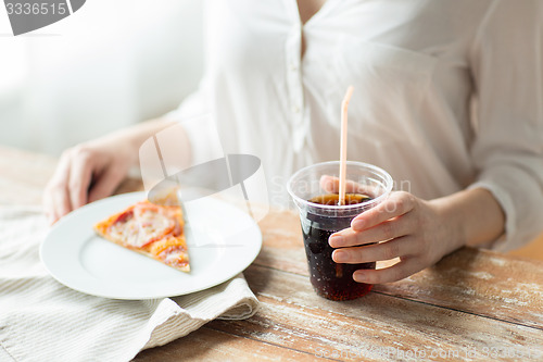 Image of close up of woman with pizza and coca cola drink