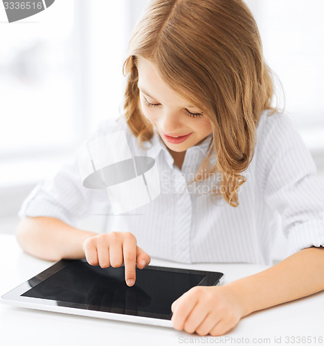 Image of smiling little girl with tablet pc at school