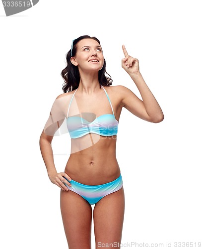 Image of happy woman in bikini swimsuit pointing finger up