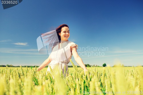 Image of smiling young woman on cereal field