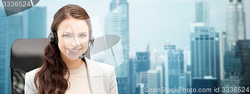 Image of smiling female helpline operator with headset