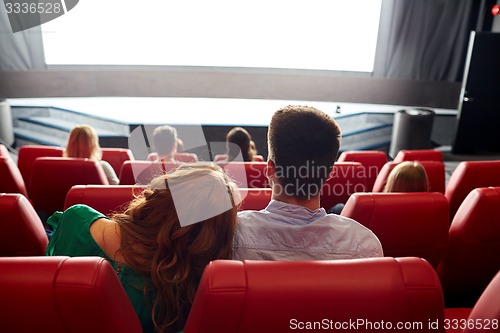 Image of happy couple watching movie in theater or cinema