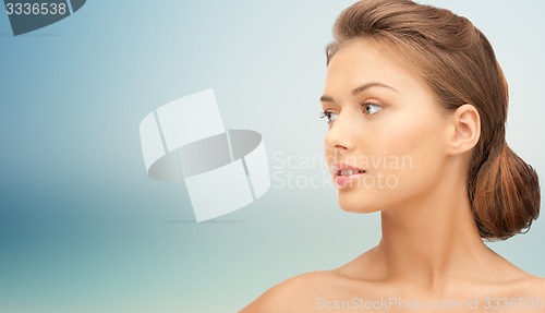 Image of beautiful young woman face looking aside