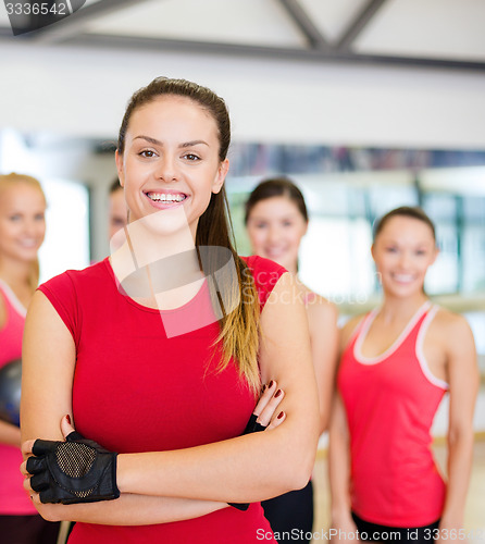 Image of woman standing in front of the group in gym