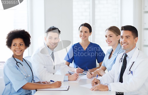 Image of group of happy doctors meeting at hospital office