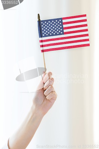 Image of close up of woman holding american flag in hand