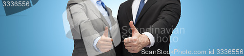 Image of businessman and businesswoman showing thumbs up