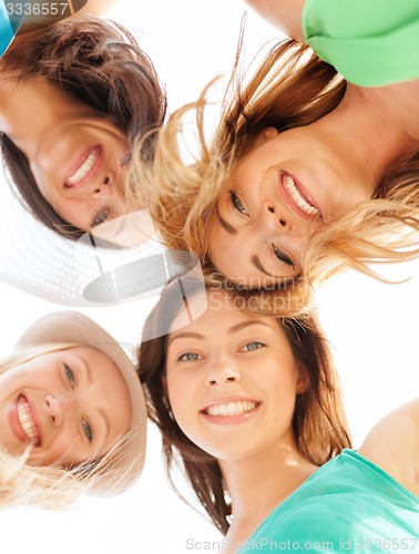 Image of faces of girls looking down and smiling