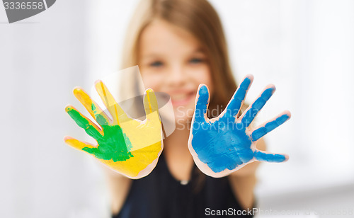 Image of girl showing painted hands