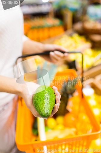 Image of close up of woman with food basket in market