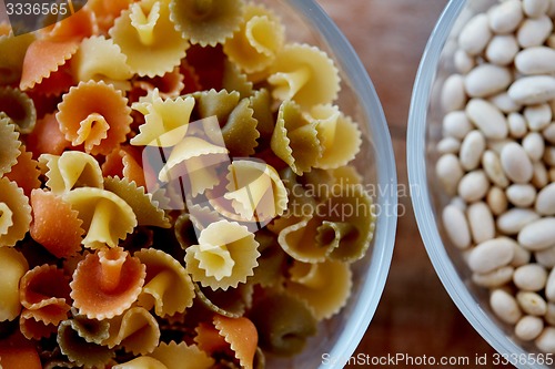 Image of close up of pasta and beans in glass bowl on table