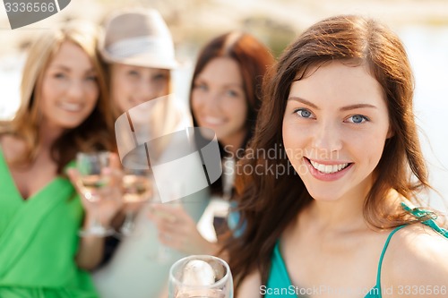 Image of smiling girls with champagne glasses