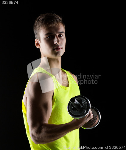 Image of young man with dumbbell