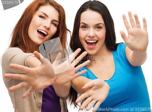 Image of two smiling girls showing their palms