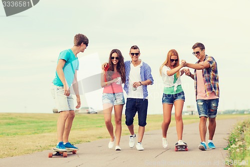 Image of group of smiling teenagers with skateboards