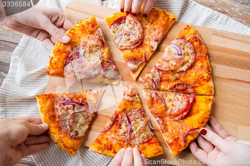 Image of close up of hands and homemade pizza
