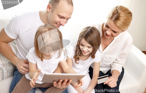 Image of happy family with tablet pc and credit card