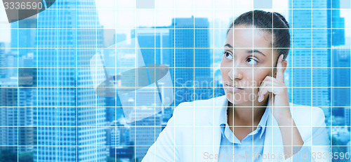 Image of african businesswoman looking up and thinking