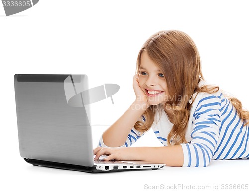 Image of smiling student girl with laptop computer lying