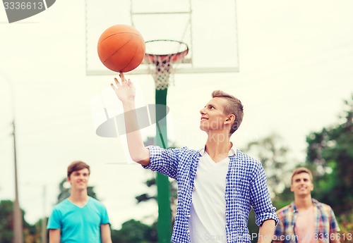 Image of group of smiling teenagers playing basketball