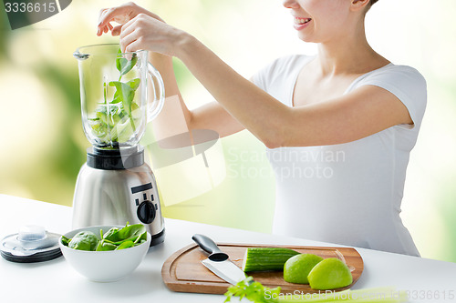 Image of close up of woman with blender and vegetables