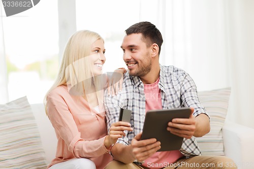 Image of happy couple with tablet pc and credit card