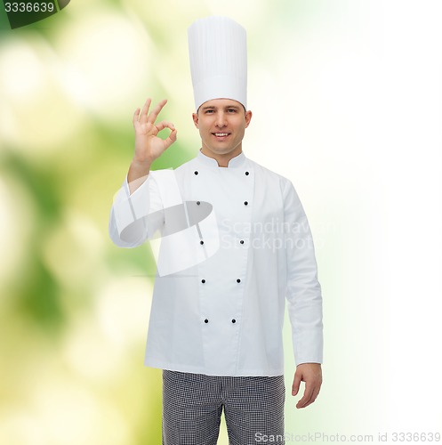 Image of happy male chef cook showing ok sign