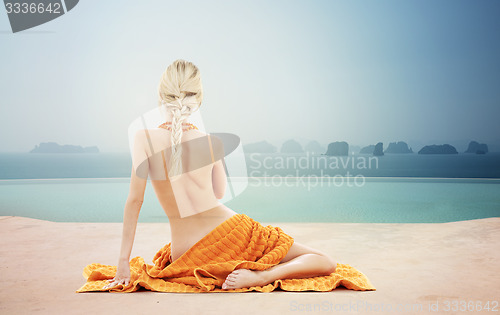 Image of beautiful young woman with orange towel