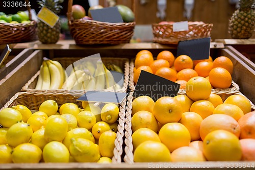 Image of fruits in baskets with nameplates at food market