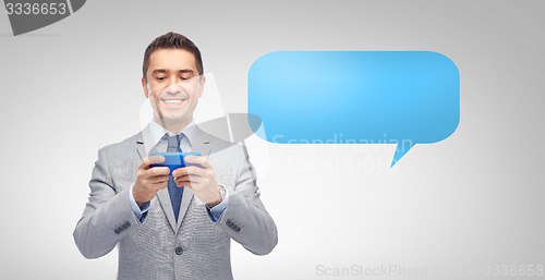 Image of happy businessman texting message on smartphone