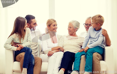 Image of happy family sitting on couch at home