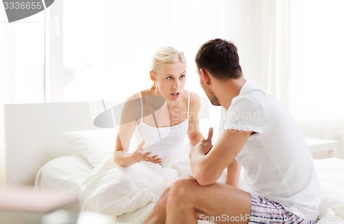 Image of unhappy couple having argument at bedroom