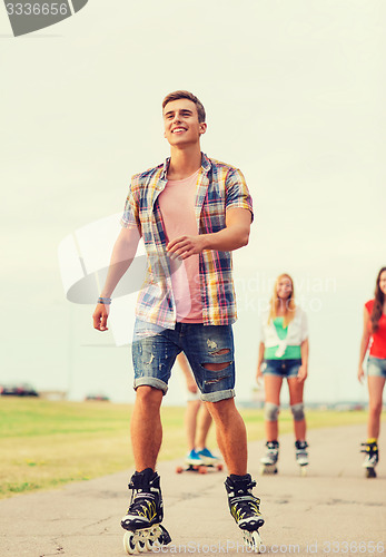 Image of group of smiling teenagers with roller-skates